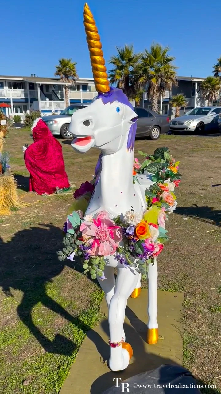 Unicorn scarecrow with a golden horn and a flower garland in San Simeon